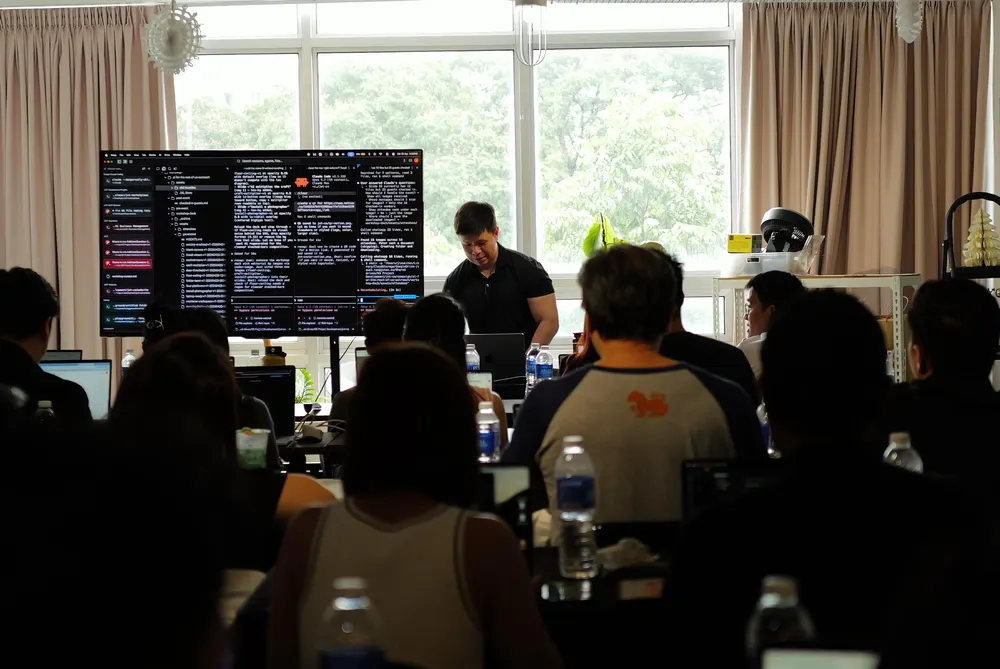 Jia Wei running a live build on screen in front of the class